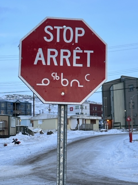 Stop sign in Iqaluit with text in English, French, and Inuktitut